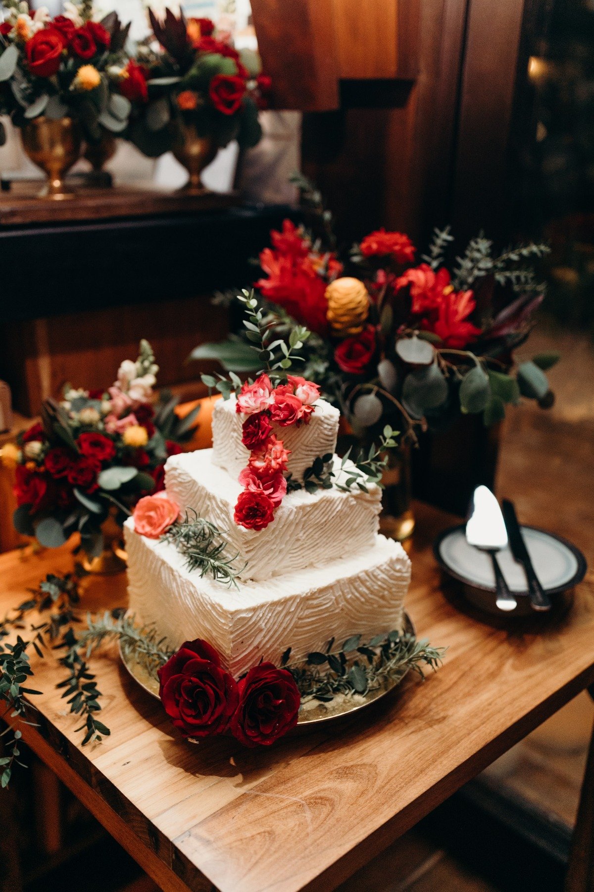 white wedding cake adorned with tropical florals