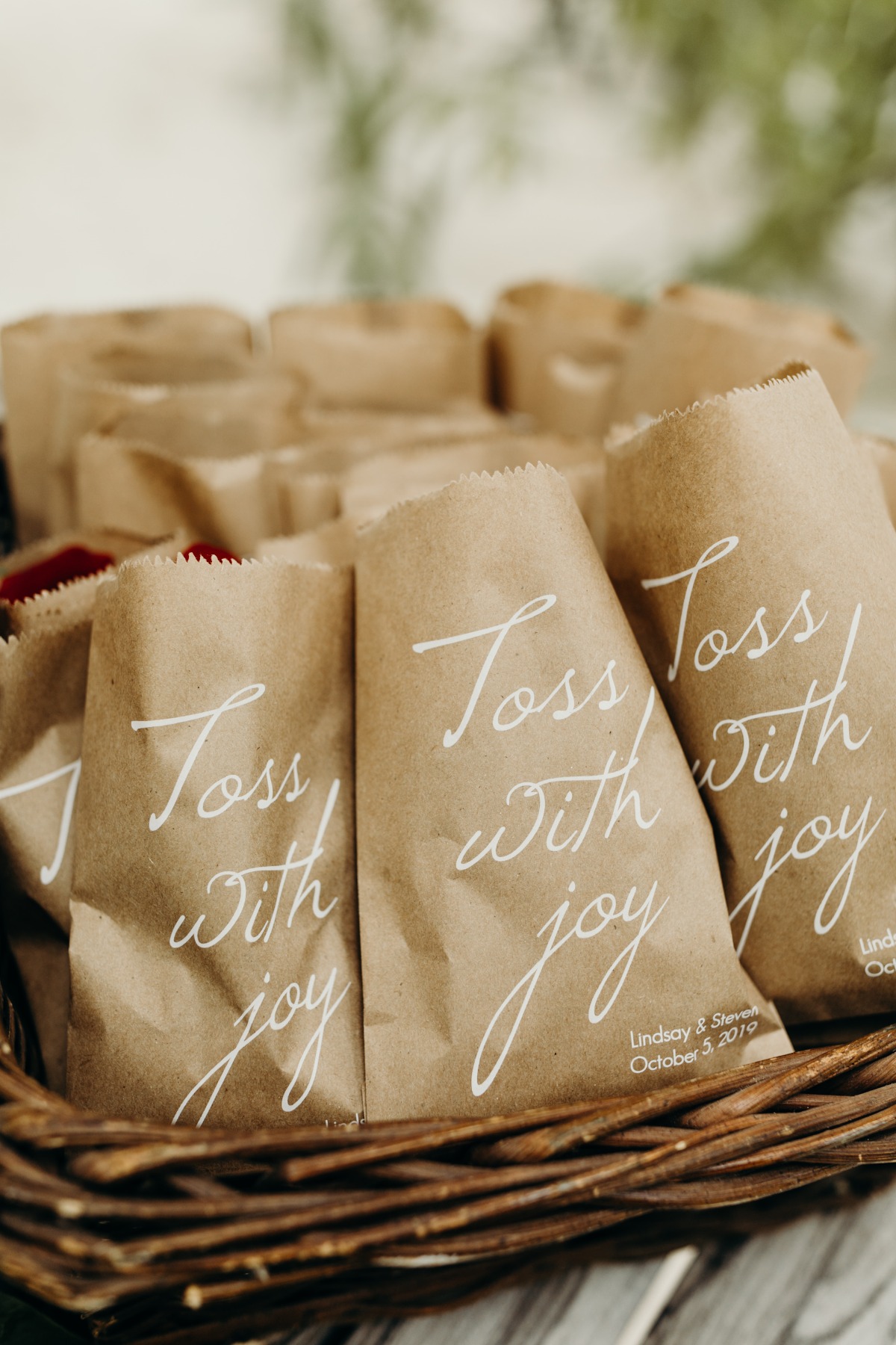 kraft wedding paper bags filled with roses to toss down the aisle