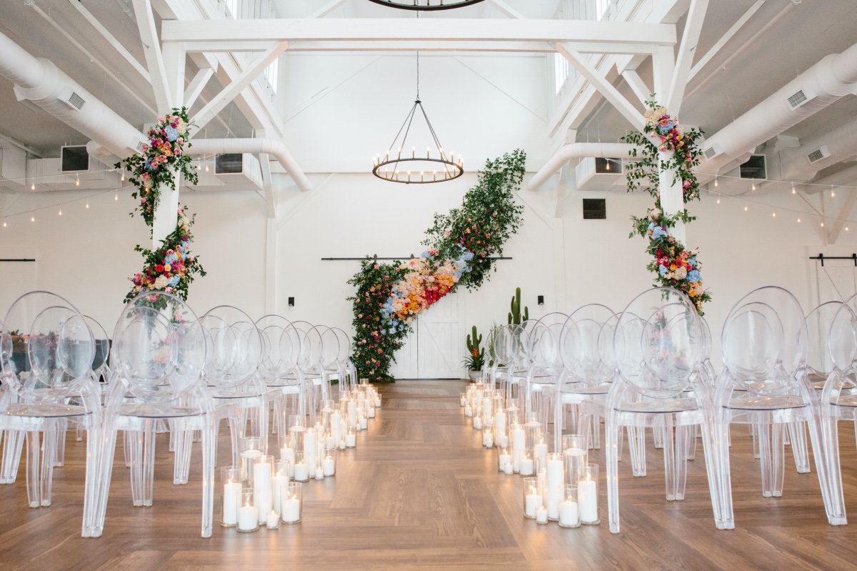 ghost chairs with a candlelit wedding aisle