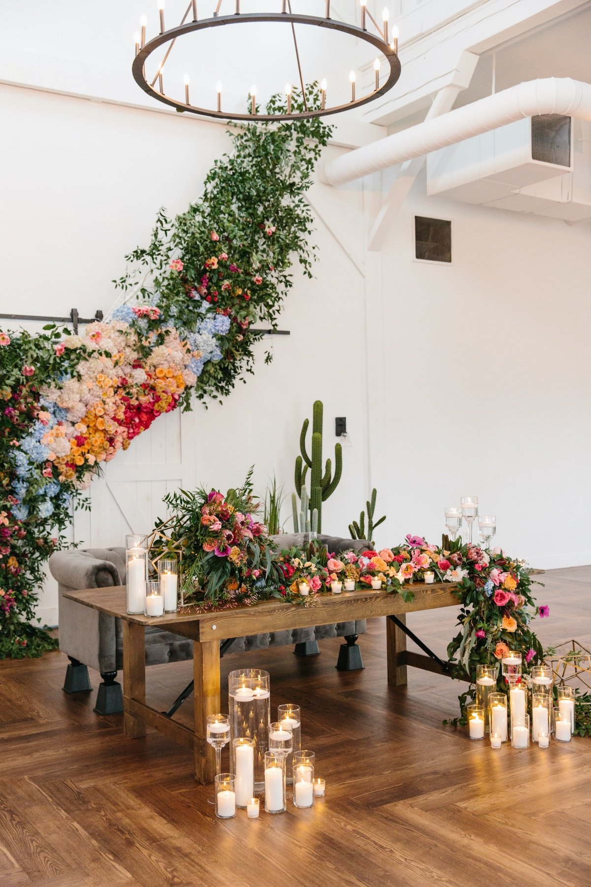 Sweetheart table design ideas with bright florals and candles