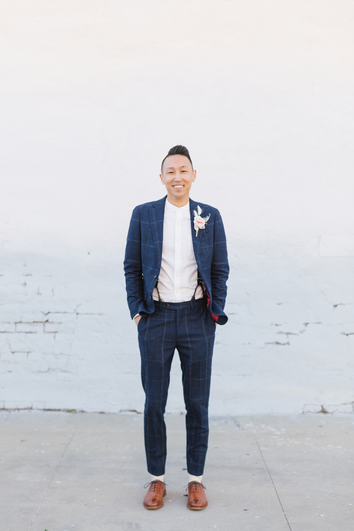 navy suit paired with pink boutonniere
