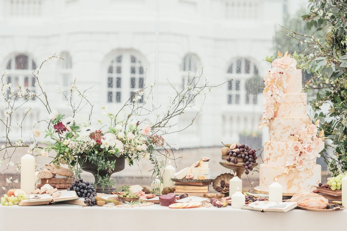 charcuterie table with wedding cake