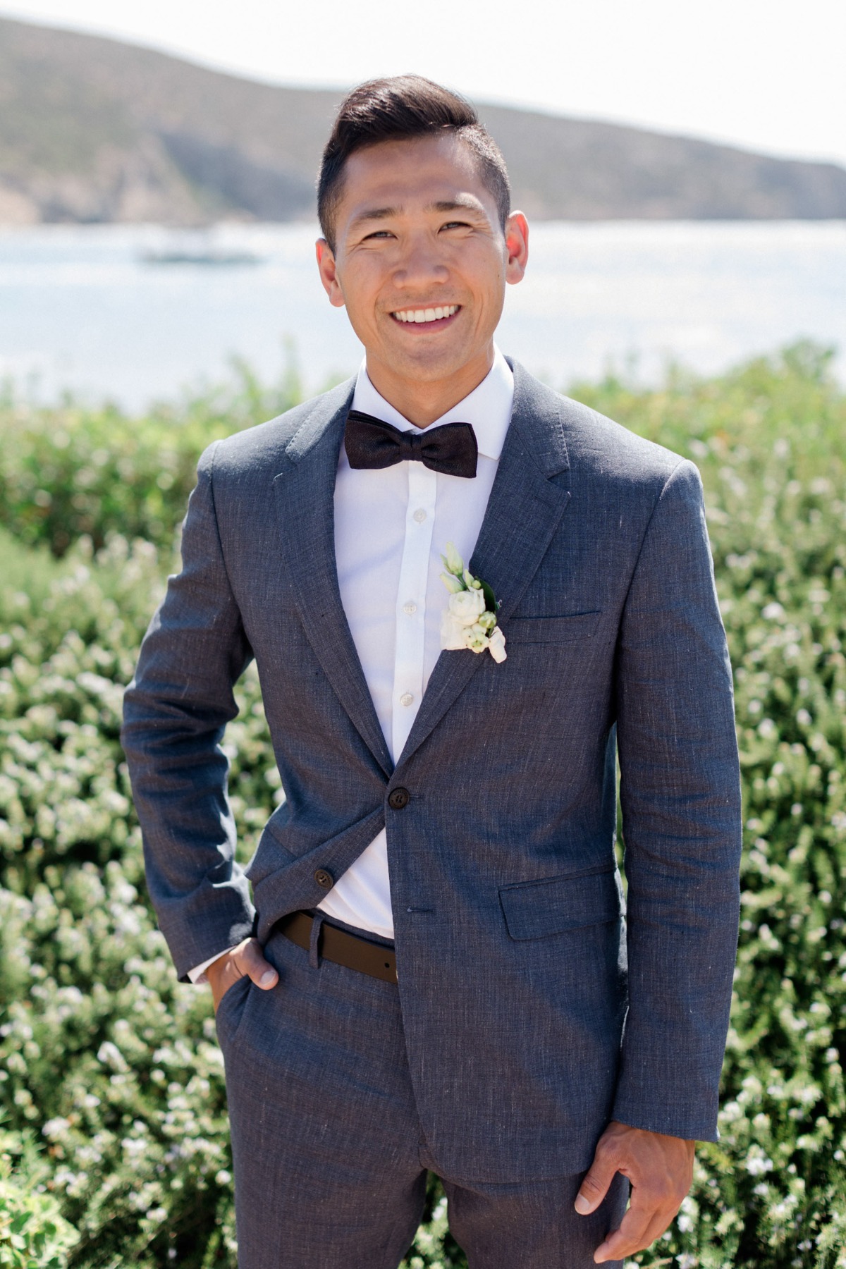 groom in bow tie suit