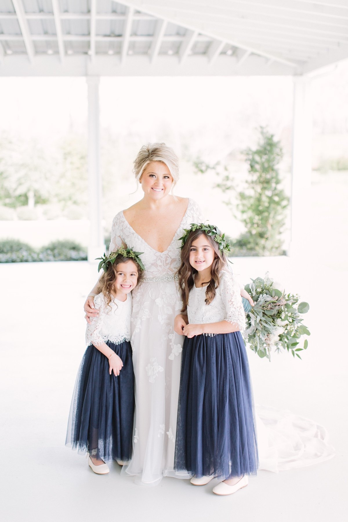 white and blue flower girl outfit idea with greenery floral crowns
