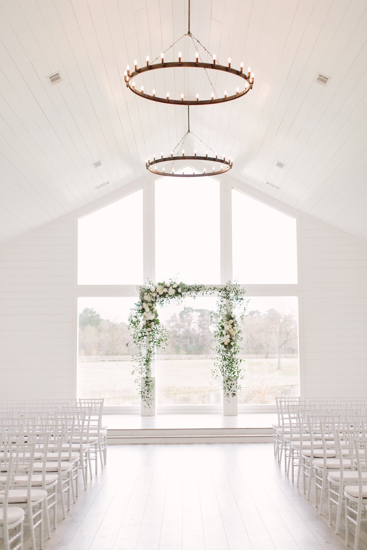 white and green florals for ceremony backdrop