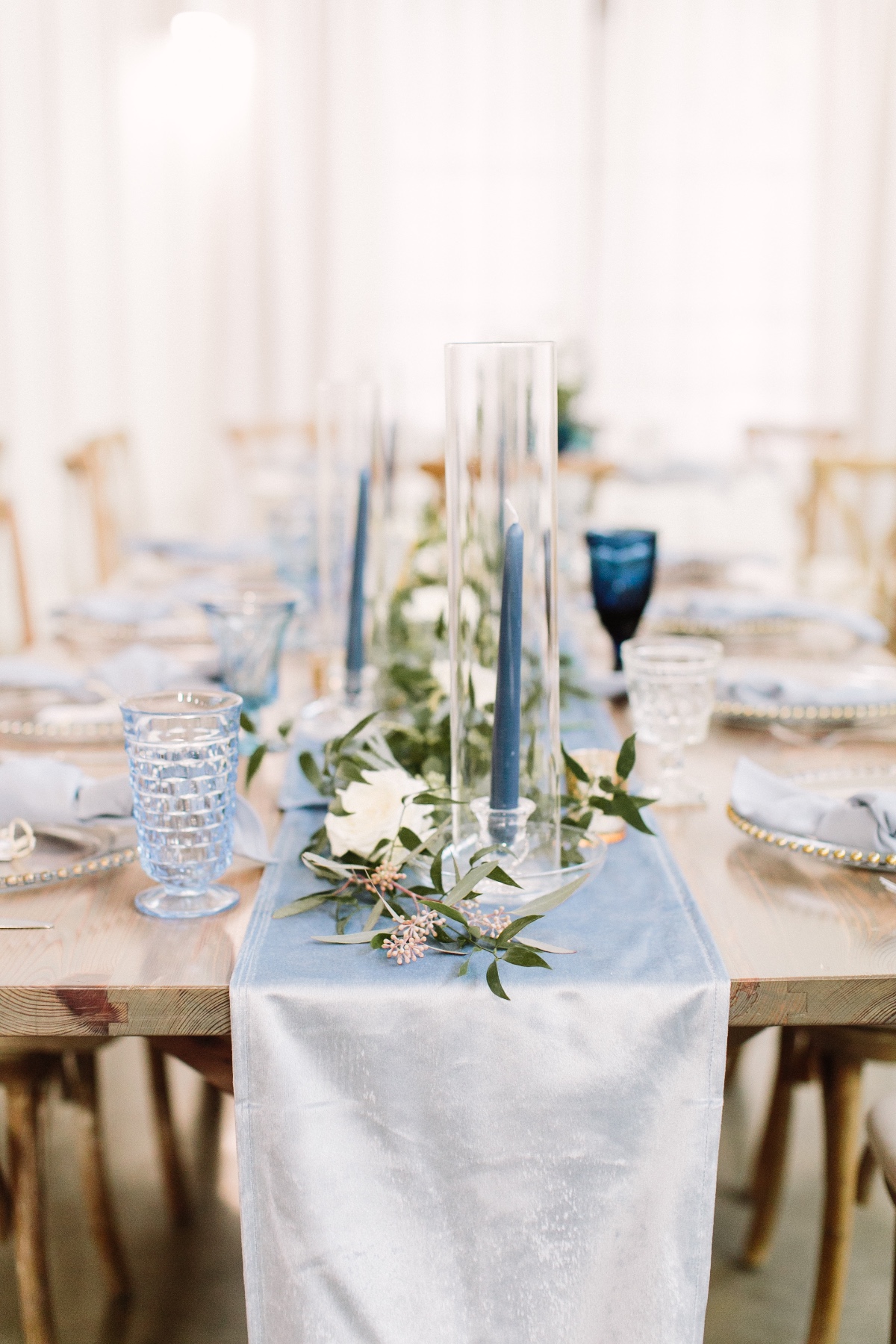 light blue satin table runner with greenery