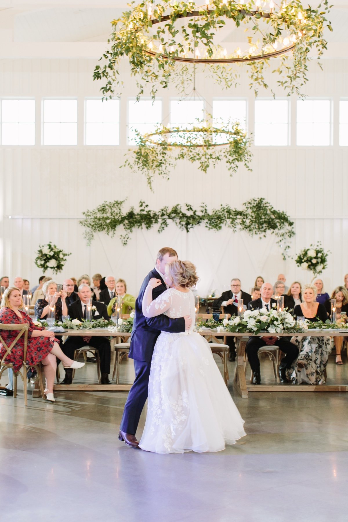 photo of the bride and groom taking their first dance as married couple