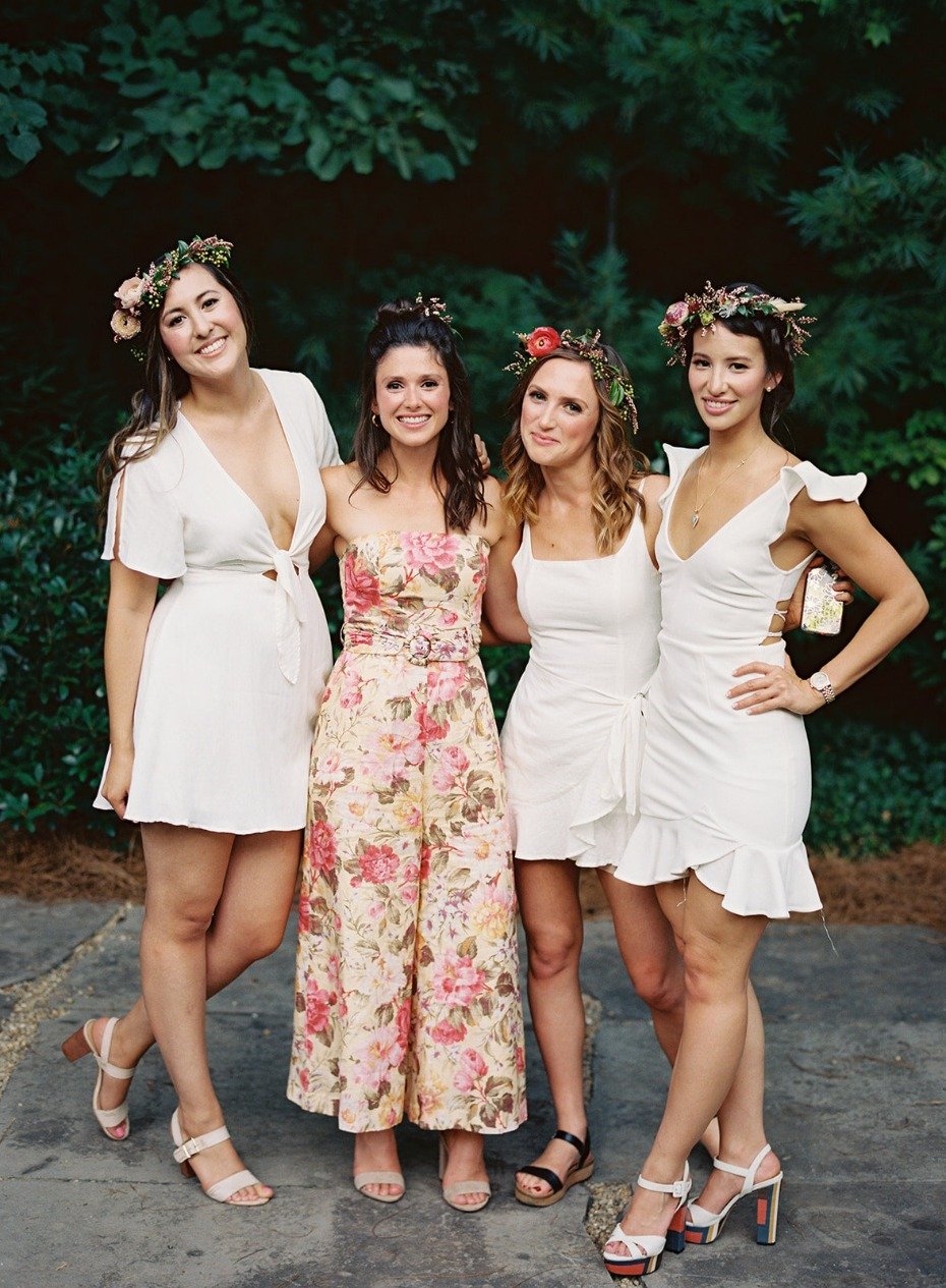 White linen welcome dinner with floral crowns