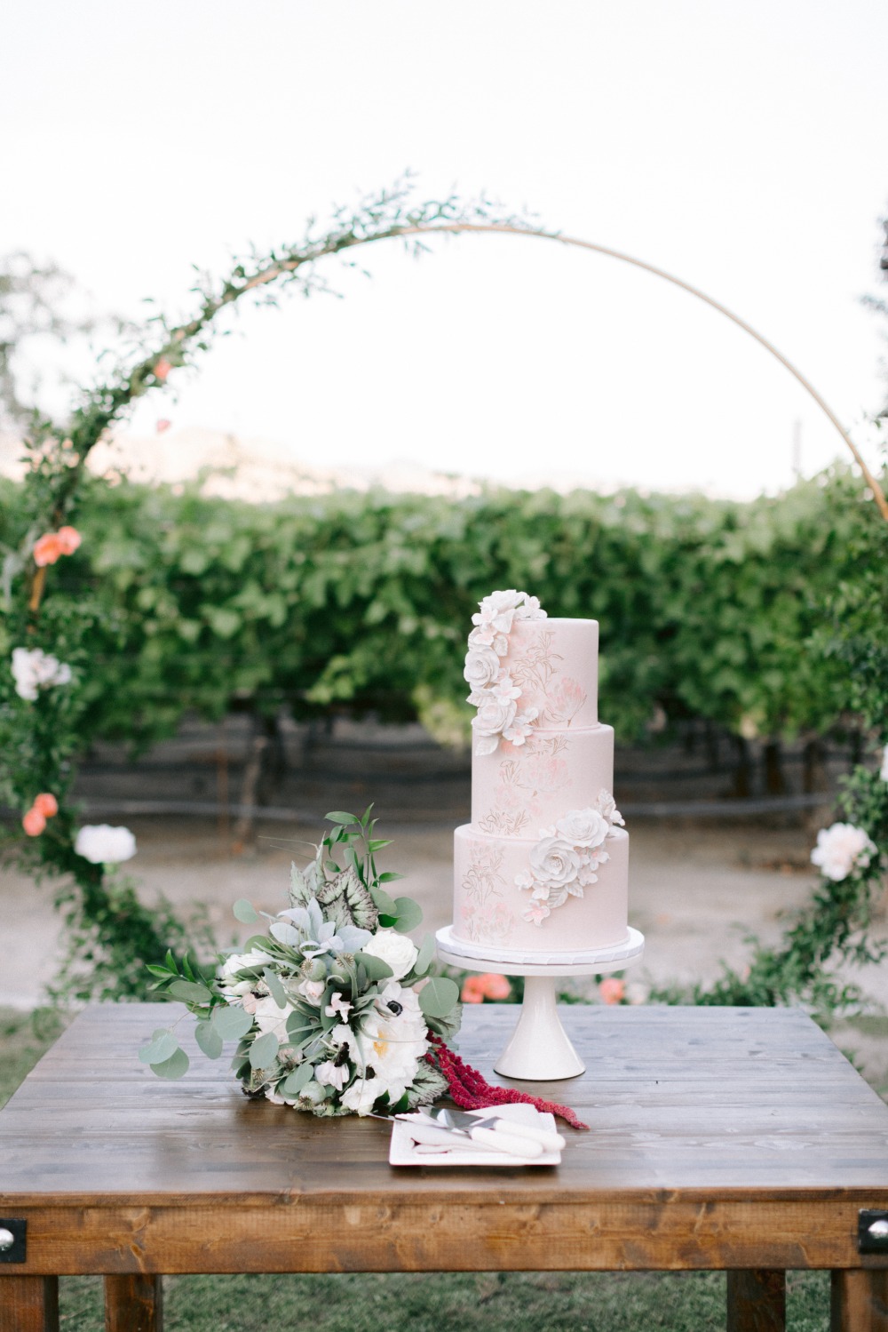 floral hoop with pink wedding cake