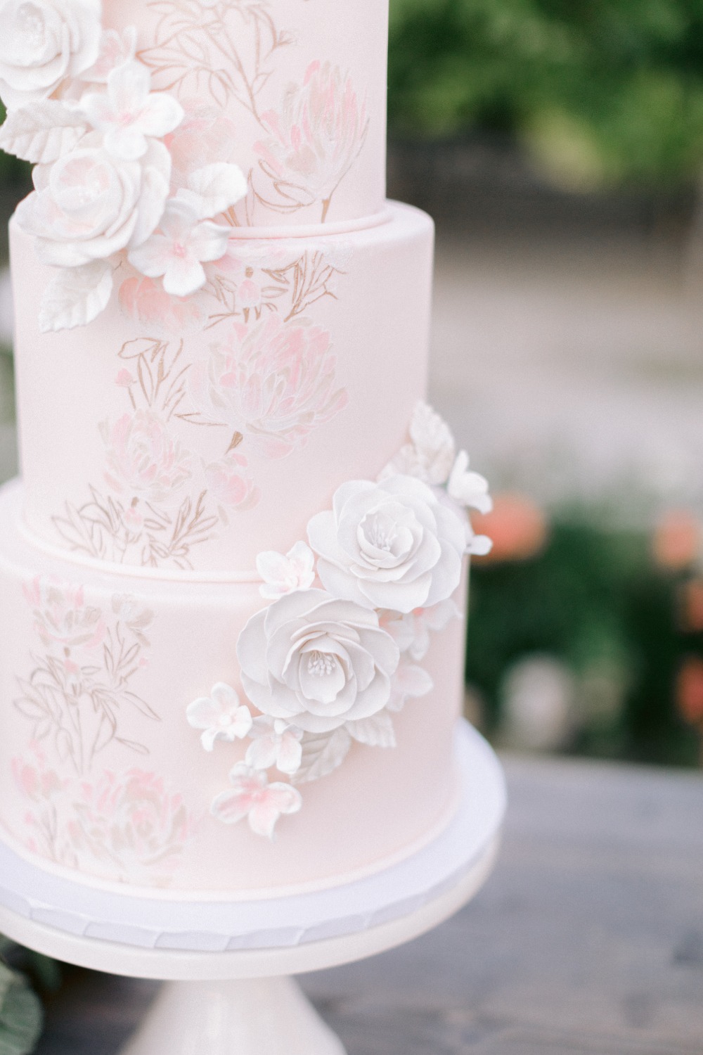 pink wedding cake with white sugar florals