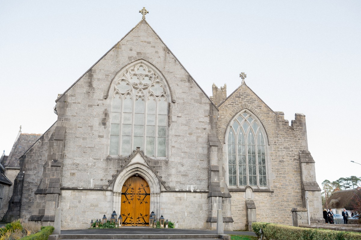 Church decorated with ivy and lanterns for wedding ceremony