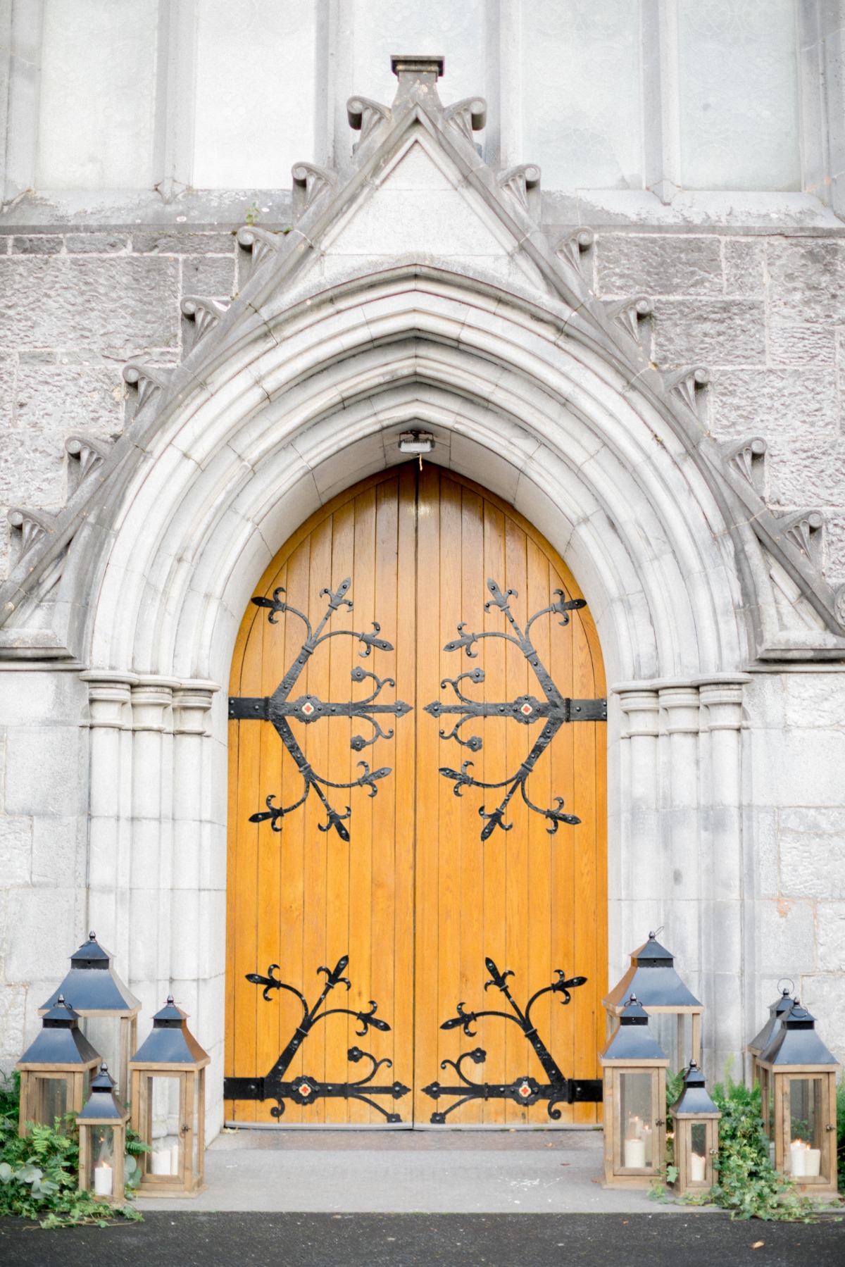 Church decorated with ivy and lanterns for wedding ceremony