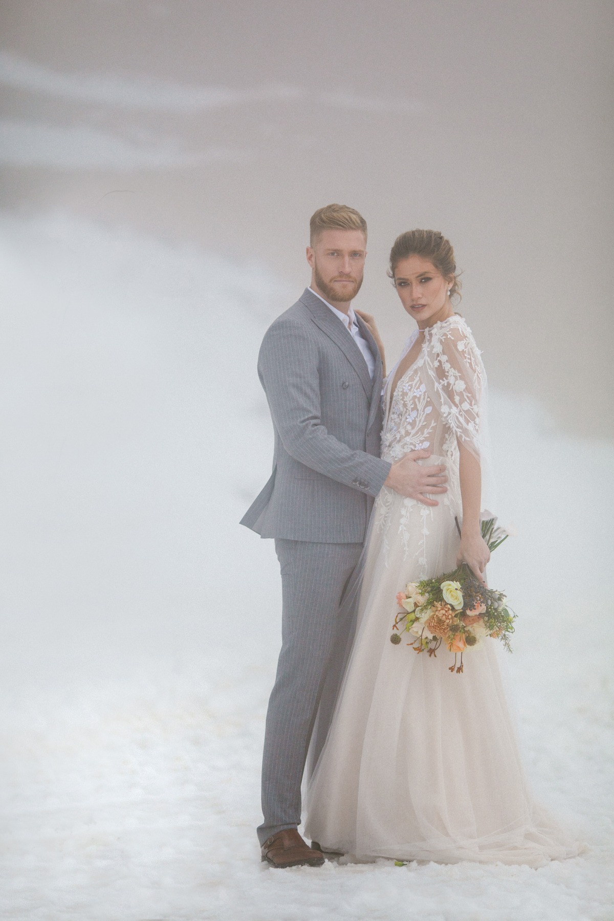 Snowy winter wedding pose ideas for bride and groom outside