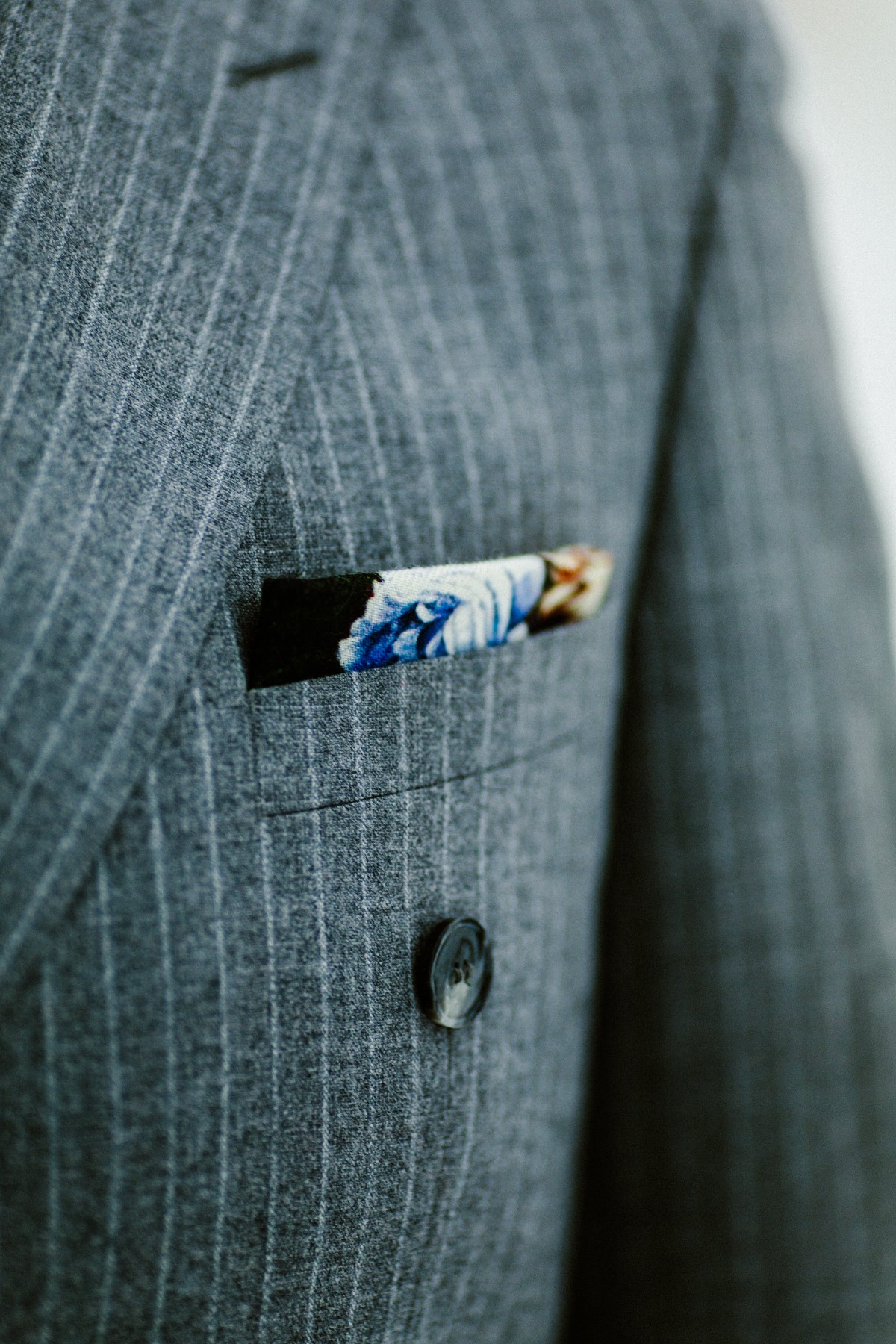 Grey pinstripe suit with a floral pocket square for a sophisticated look