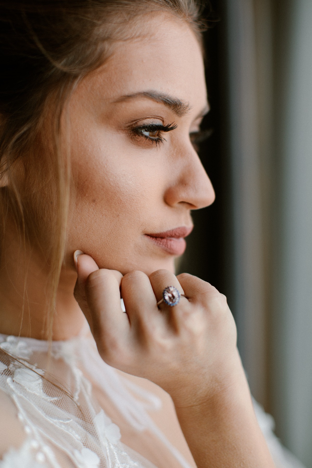 Beautiful woman with engagement ring, thoughtful portrait