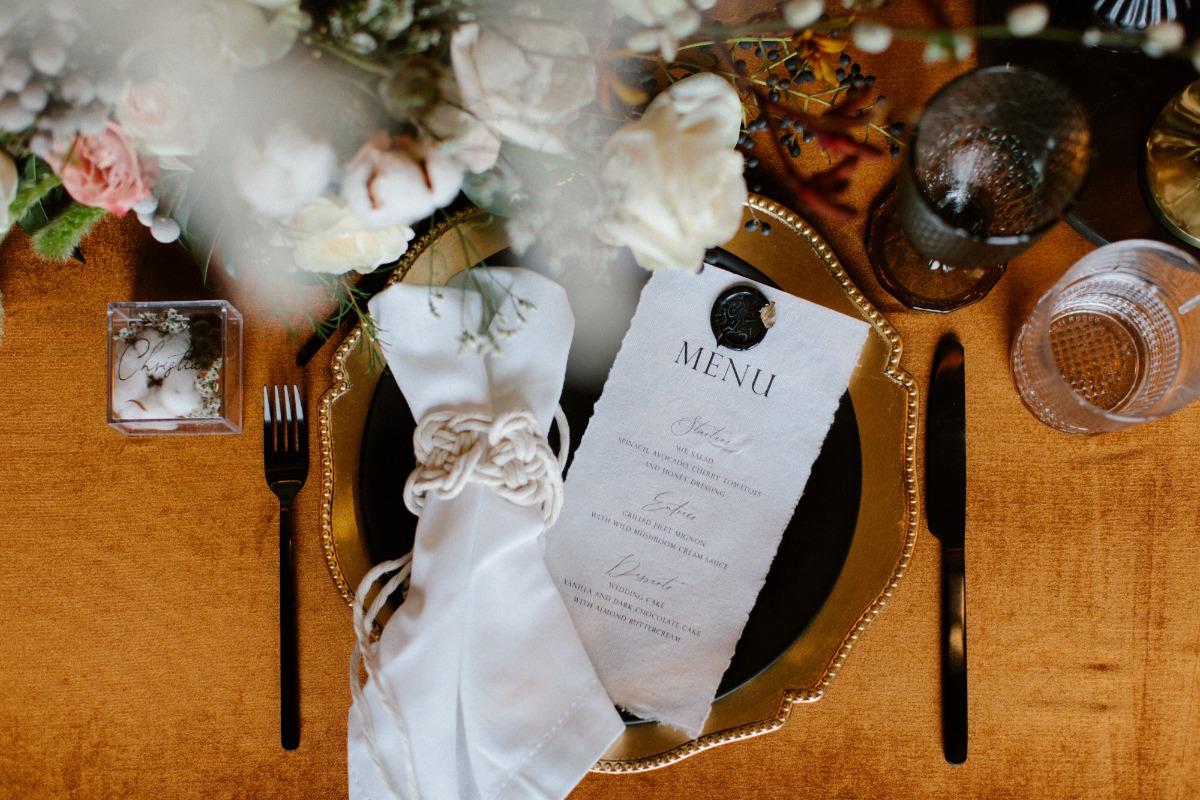 Elegant wedding table setting with menu and floral arrangement