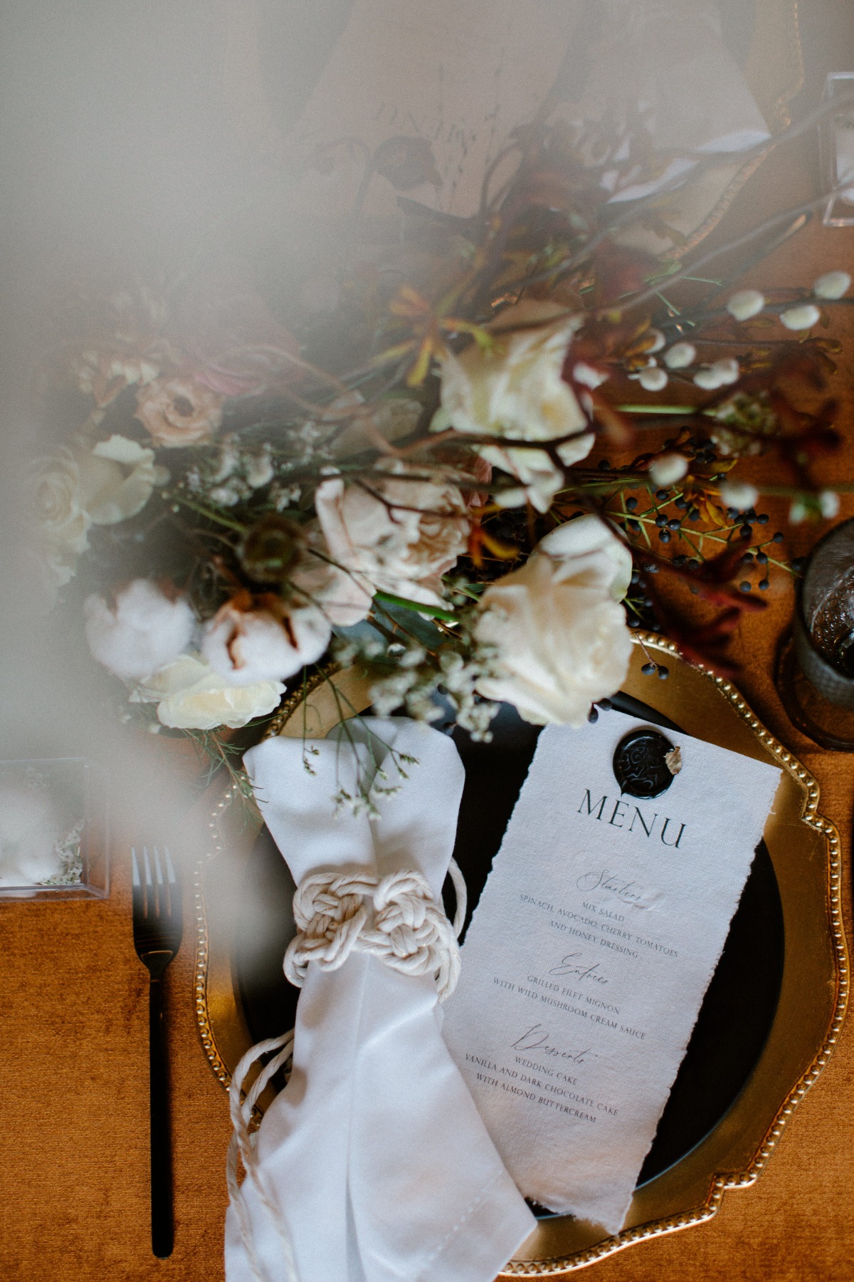 Elegant wedding table setting with menu and floral arrangement
