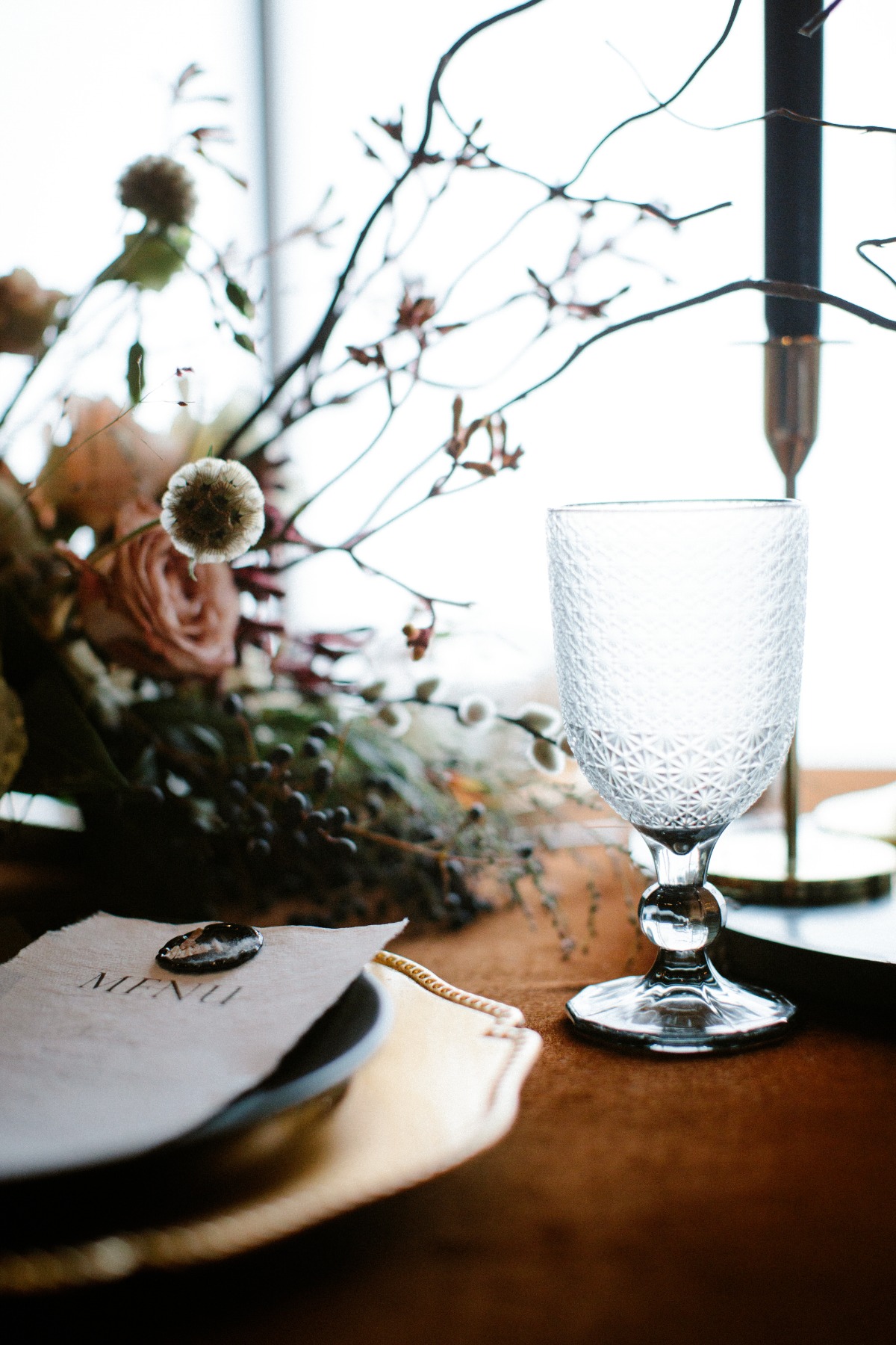 Elegant table setting with floral arrangement and crystal glass
