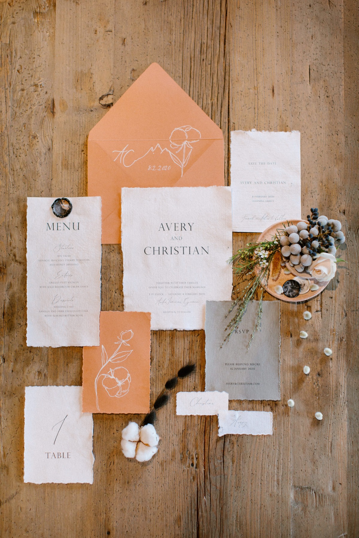 Rustic wedding stationery with cotton flower accents and details