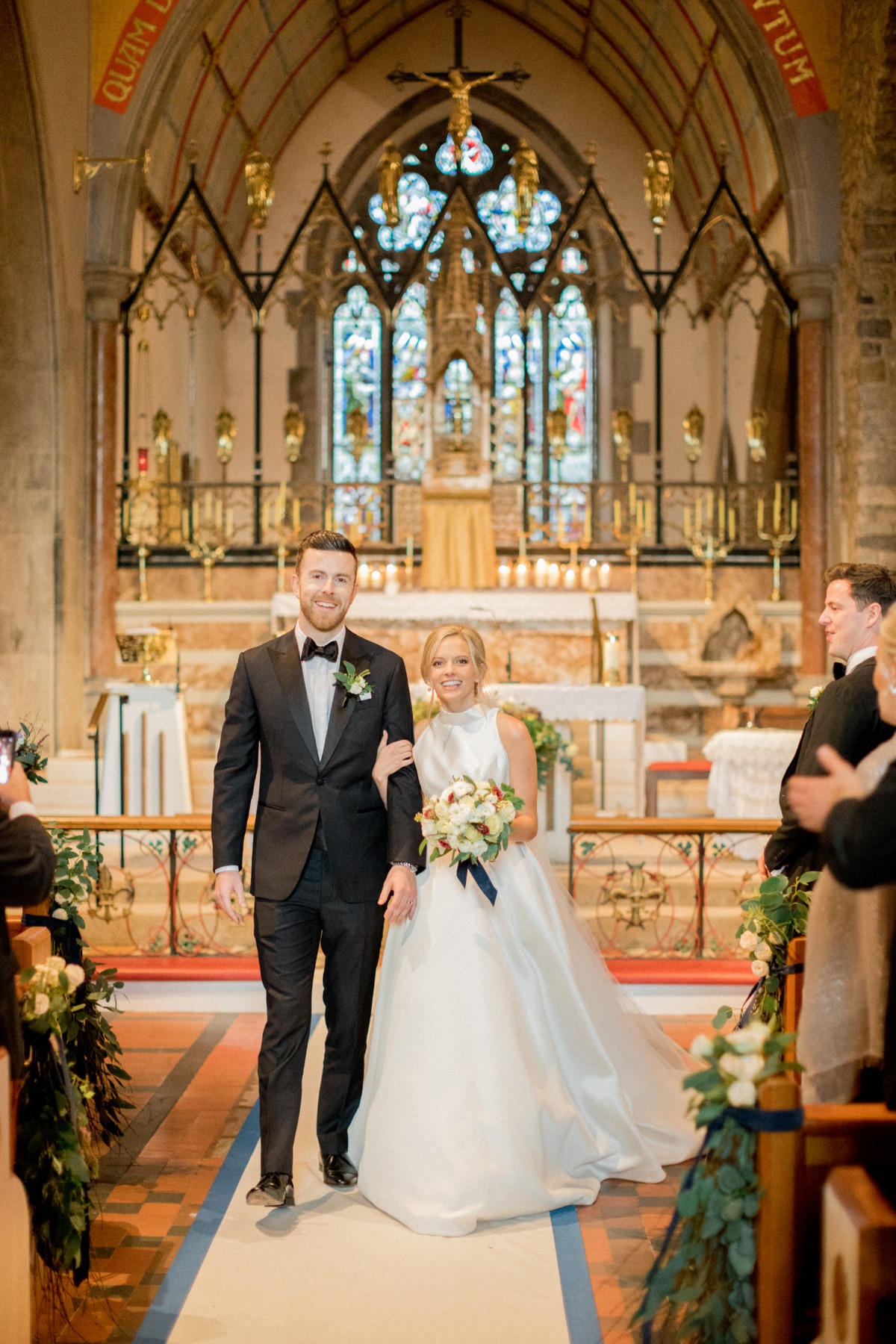 Bride and groom walk down the aisle in a church ceremony