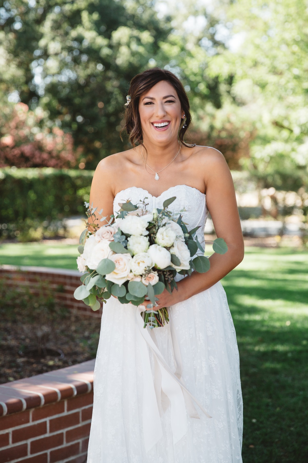 strapless wedding dress with white wedding bouquet