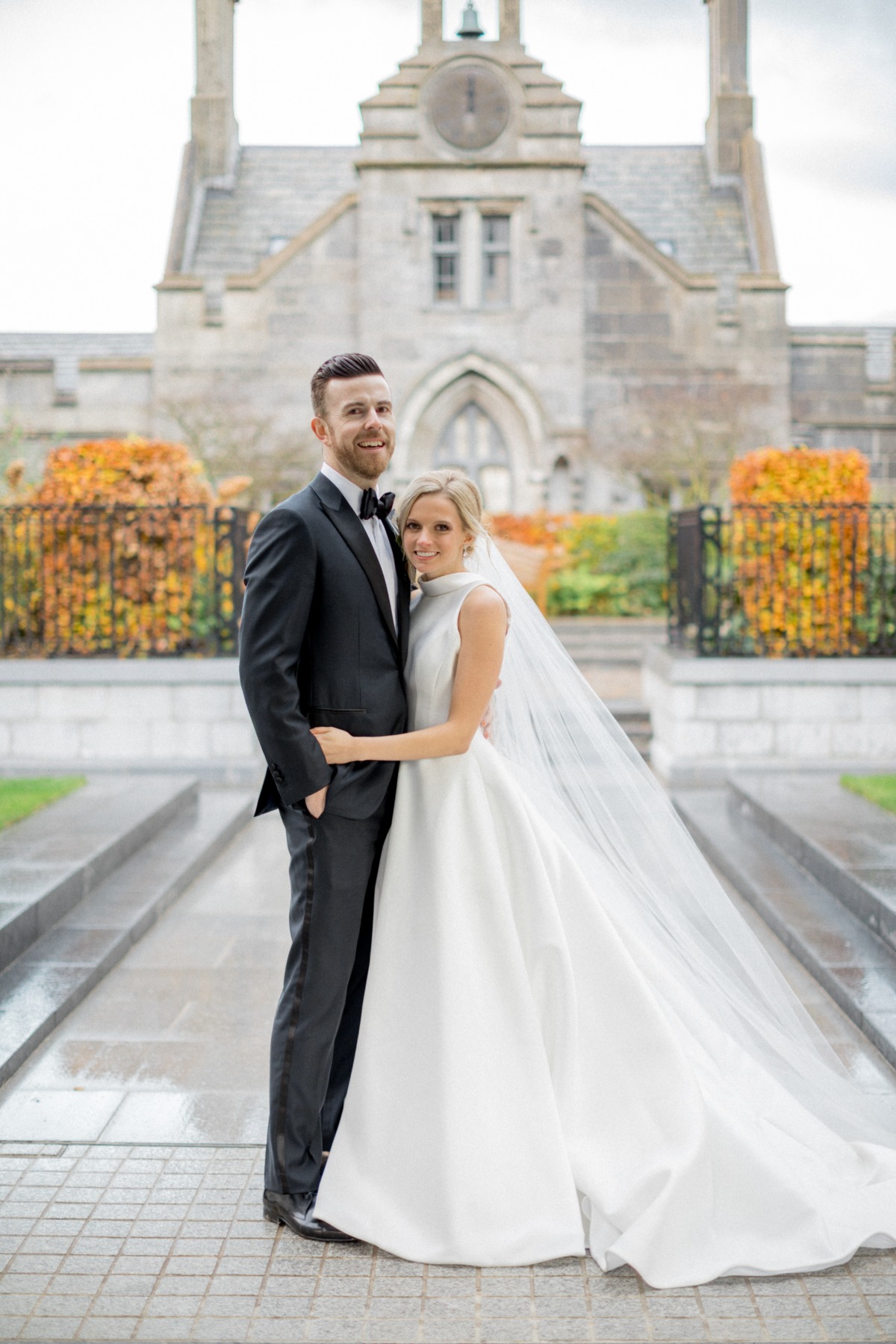Happy couple on their wedding day posing in front of a building