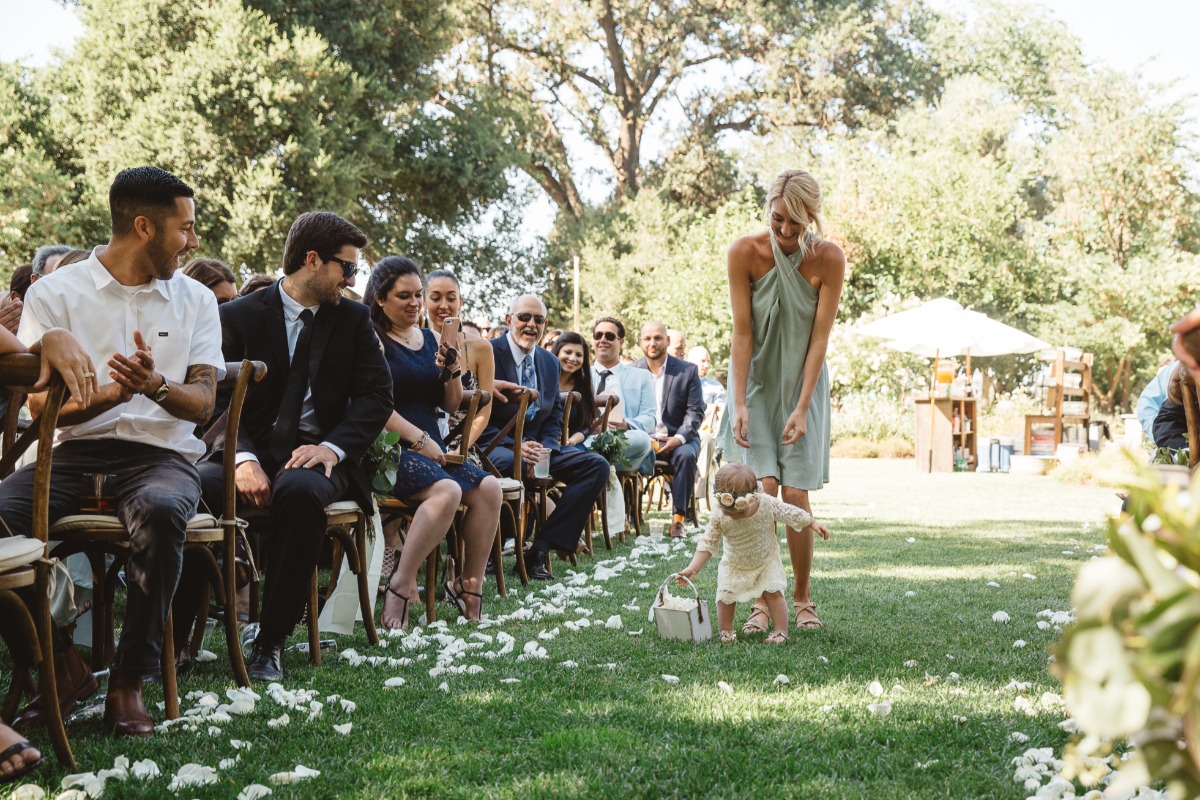 flower girl walking down the aisle