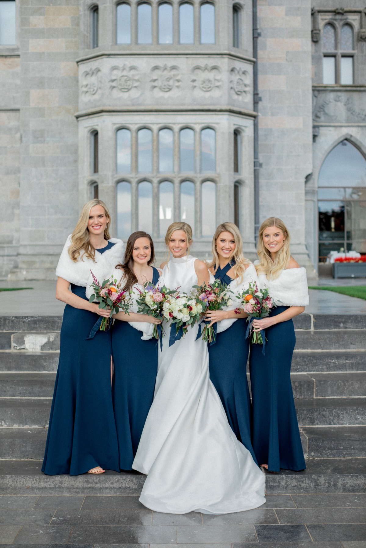 Navy Blue Bridesmaid dresses from Jenny Yoo paired with white fur stoles