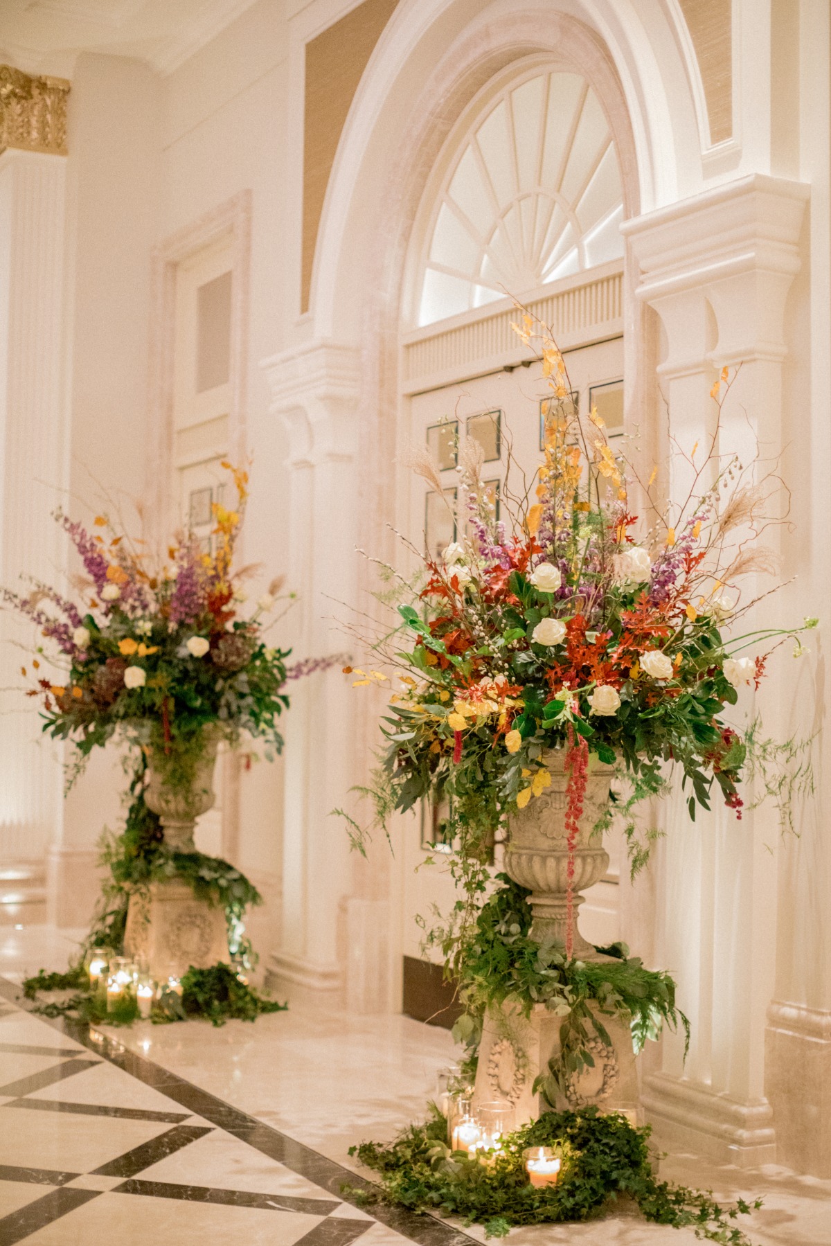 Elegant floral arrangements in urns at a formal venue