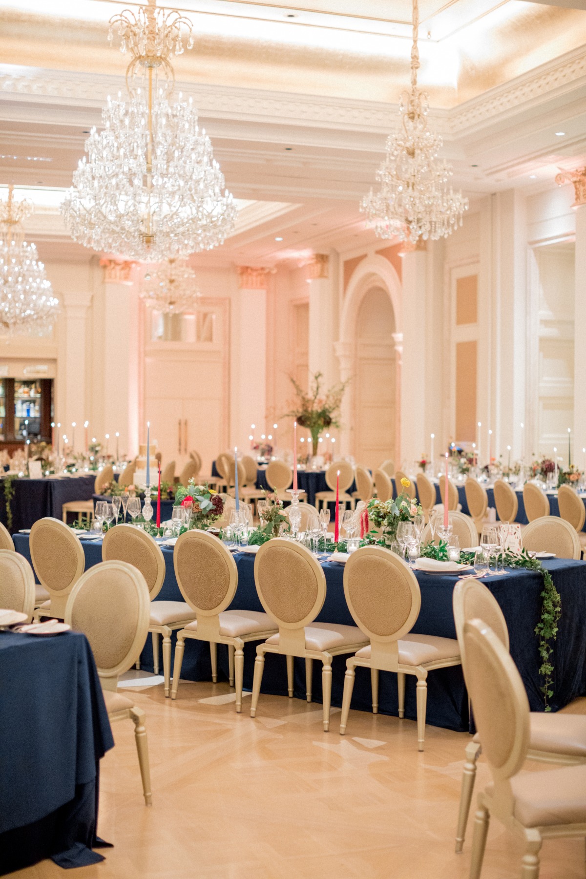 Elegant wedding reception tables with stunning chandeliers overhead