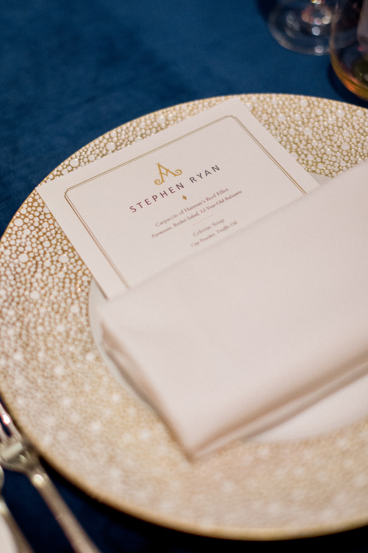 Elegant place setting with menu card at formal dining event