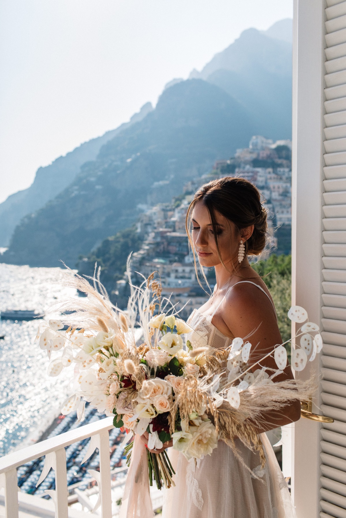 bride holding dried floral bouquet designed by Rosalinda Rellino