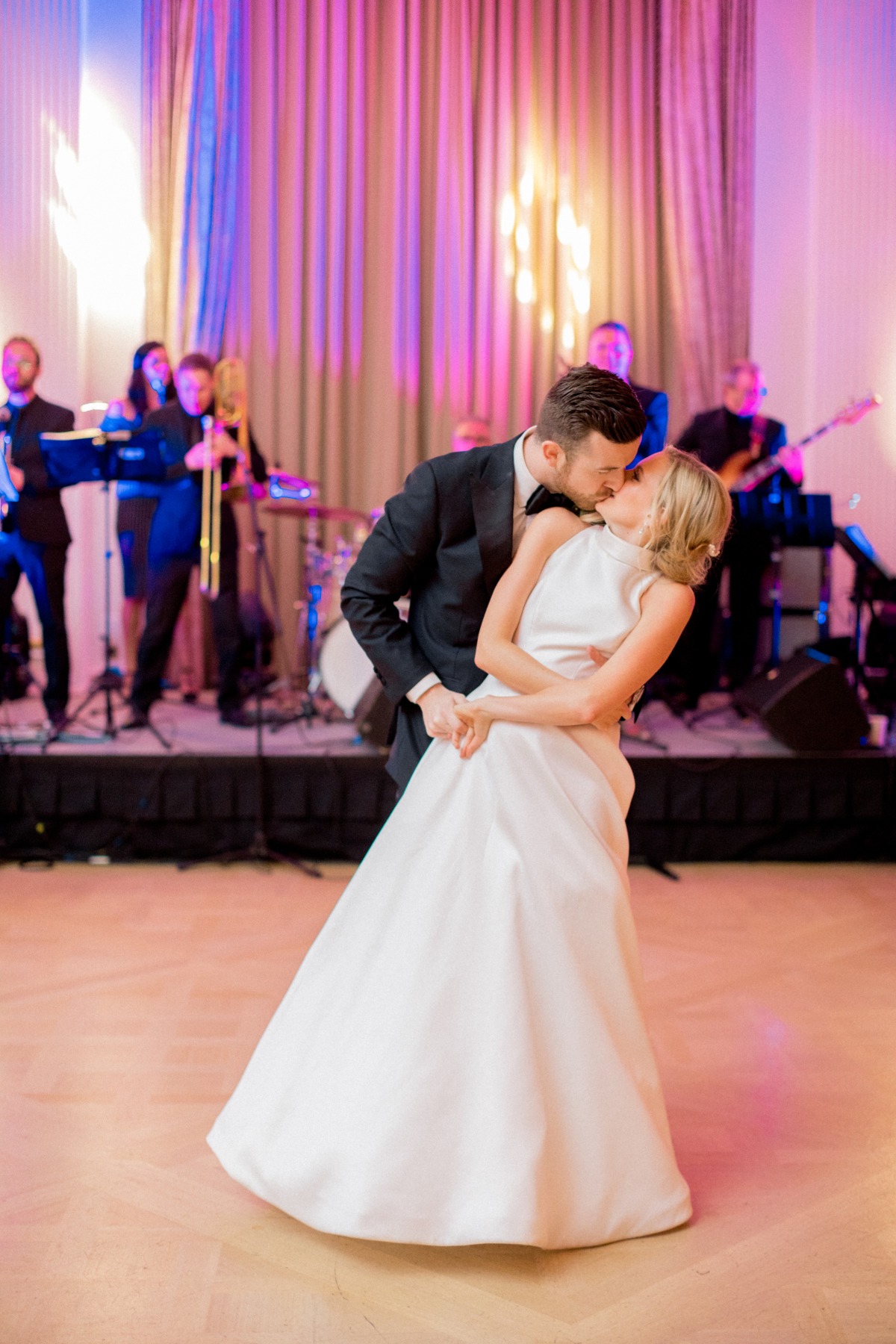 Bride and groom share a kiss during their wedding reception
