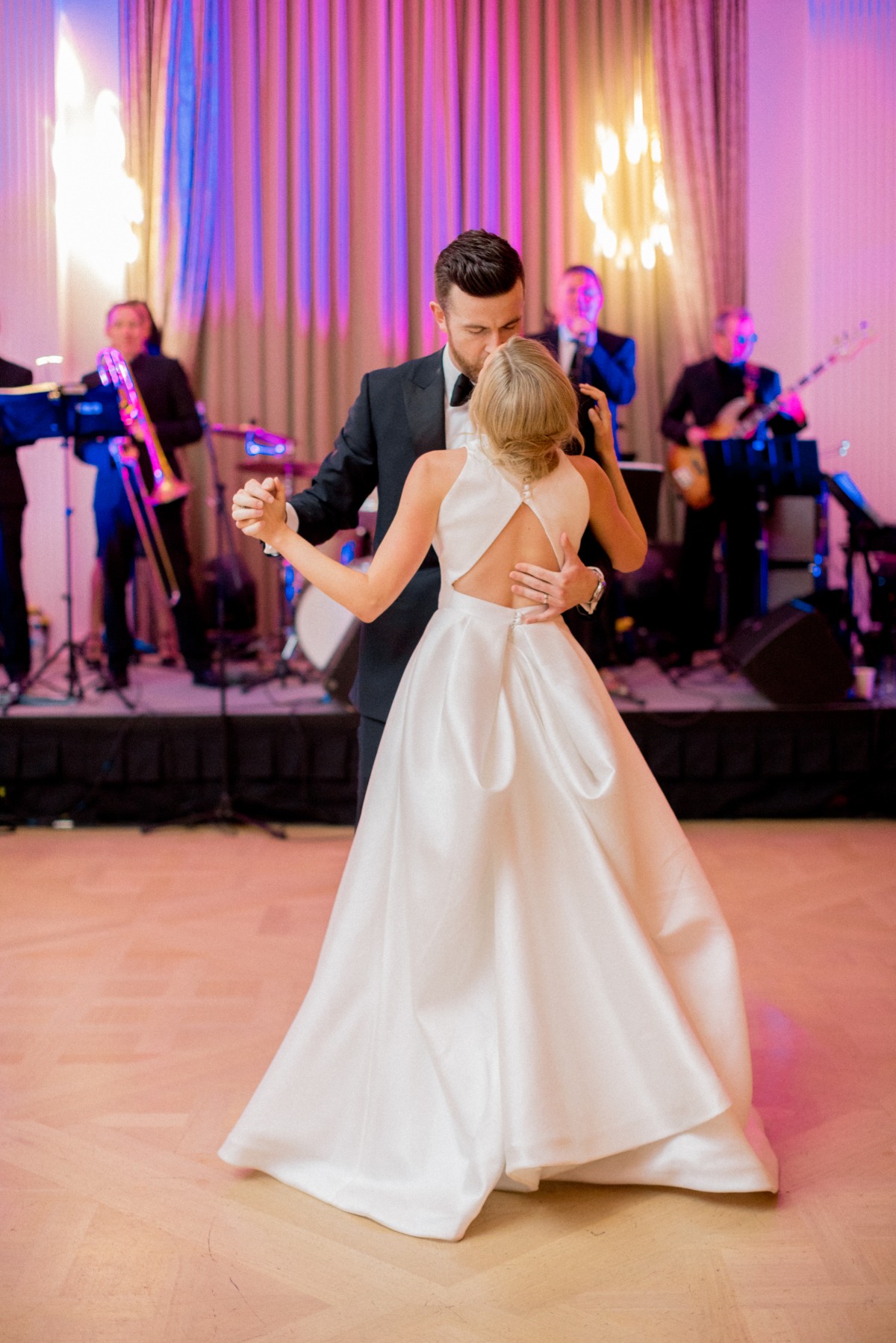 Bride and groom dance with band at wedding reception