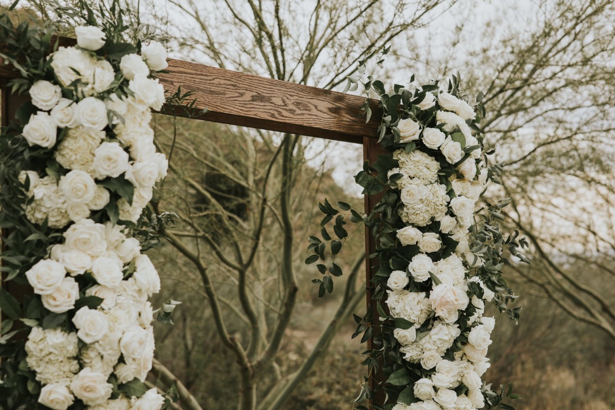 wedding ceremony backdrop adorned with florals
