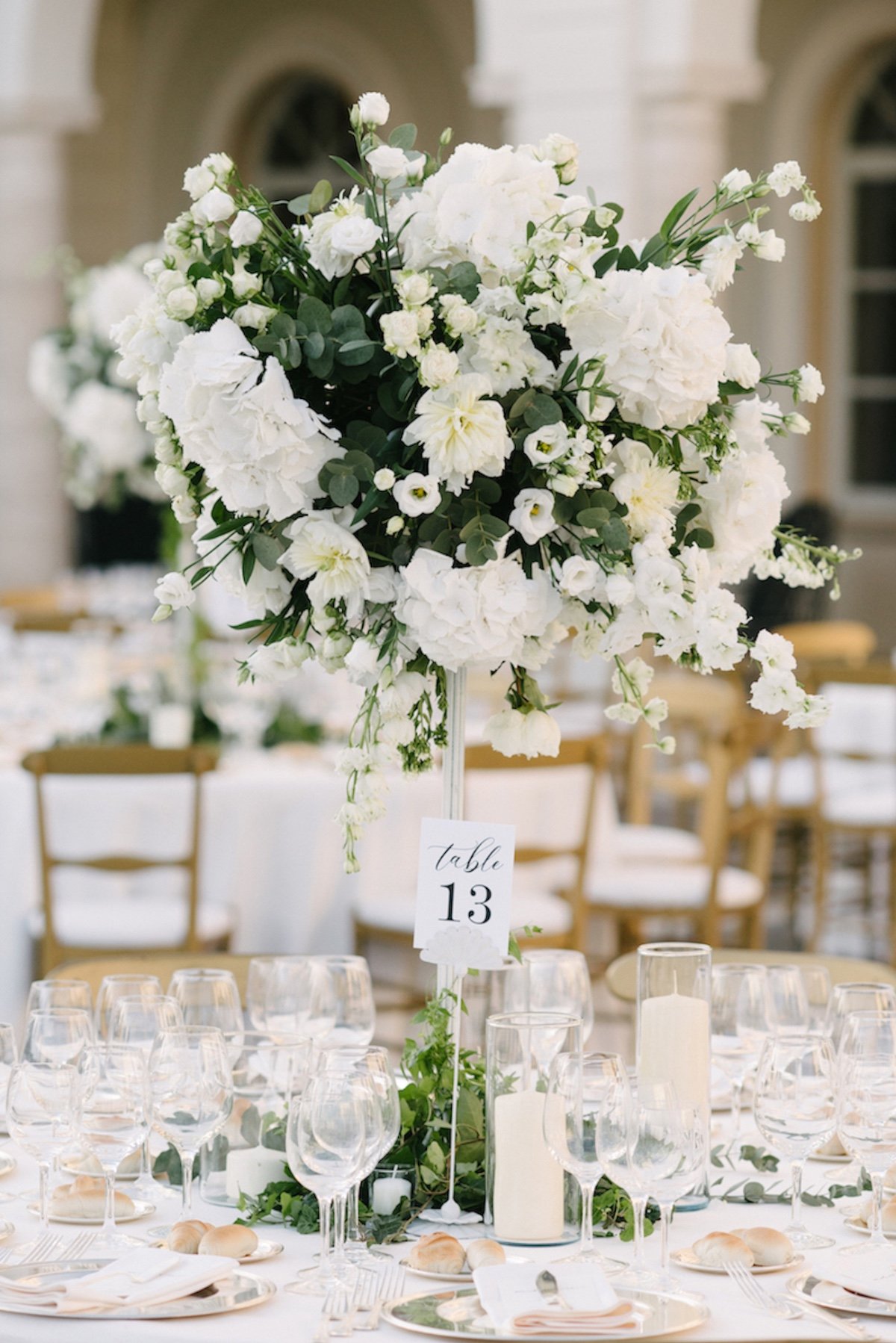 tall white wedding centerpieces with table numbers
