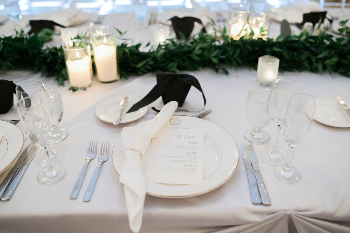 black and white table decor with greenery