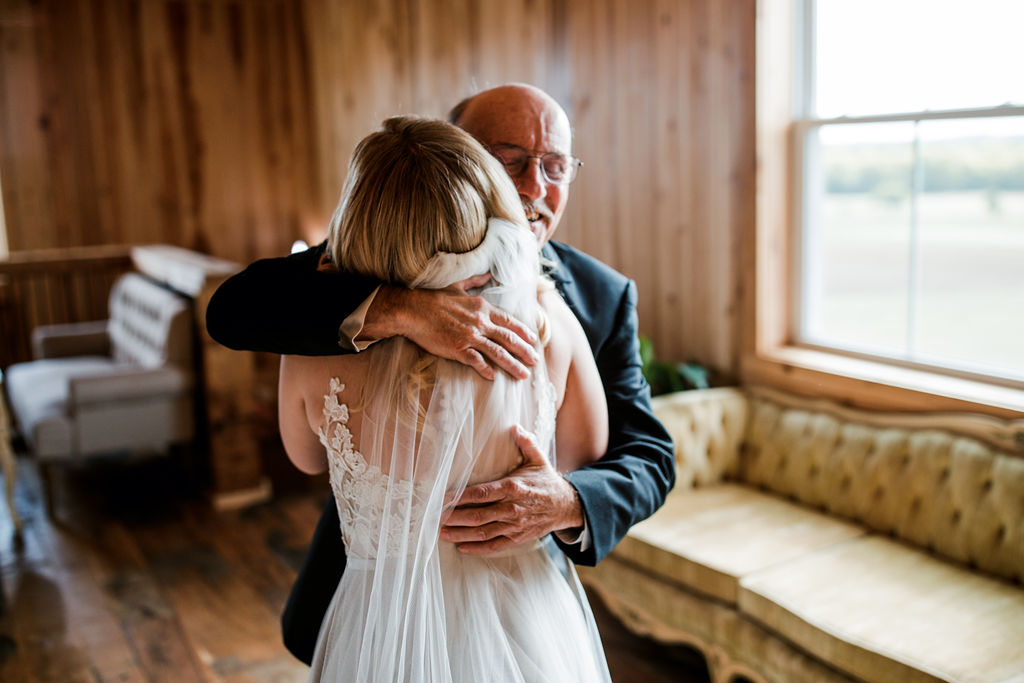 Bride and father share emotional hug on wedding day