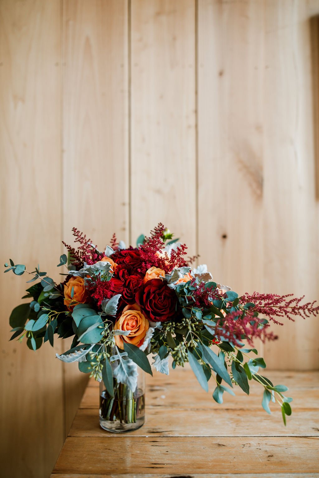 red rose, orange and eucalyptus wedding bouquet