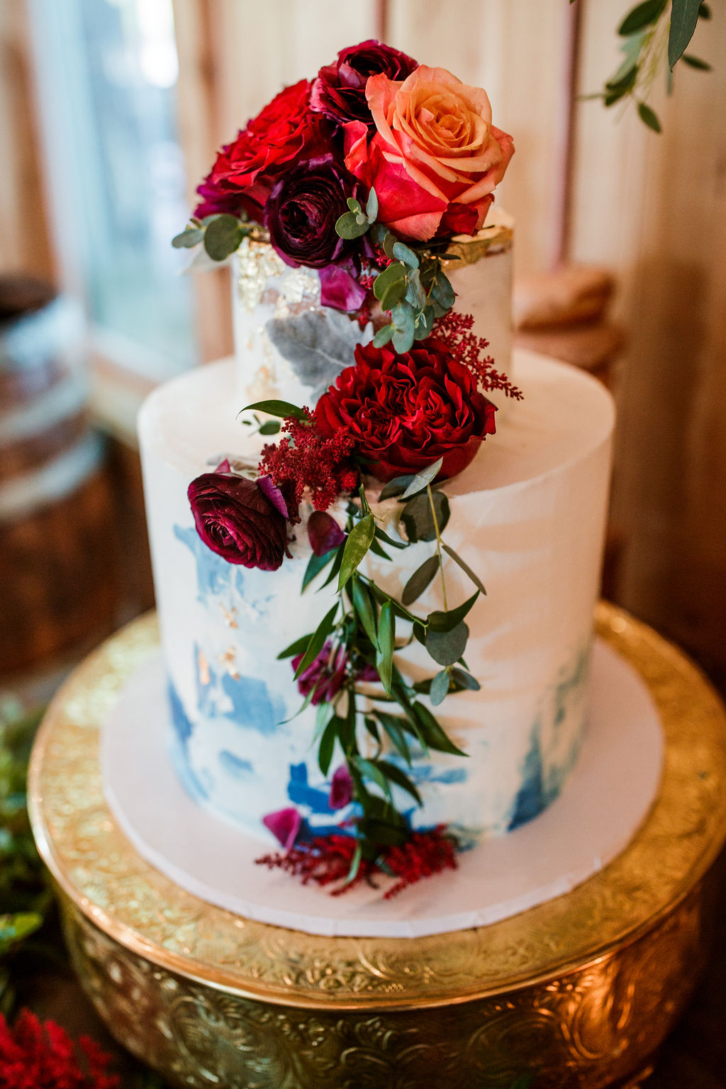 light blue wedding cake on gold cake stand