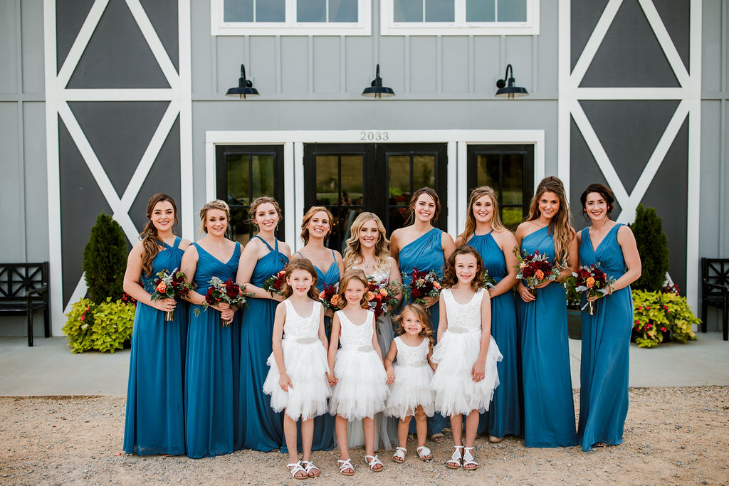 mismatched styled sky blue bridesmaid dresses with white flower girl dresses