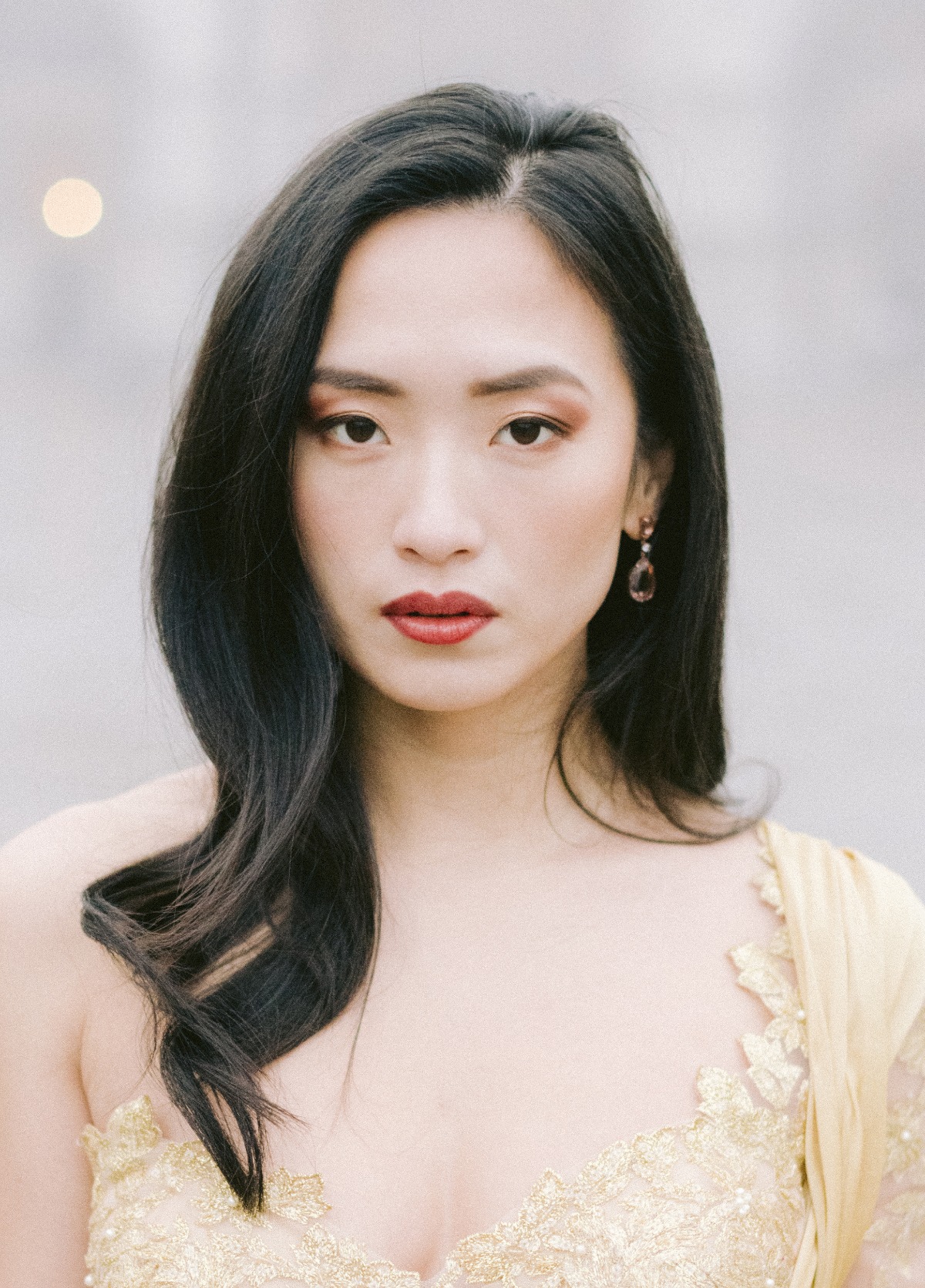 Elegant Asian woman with dark hair and red lipstick, closeup portrait