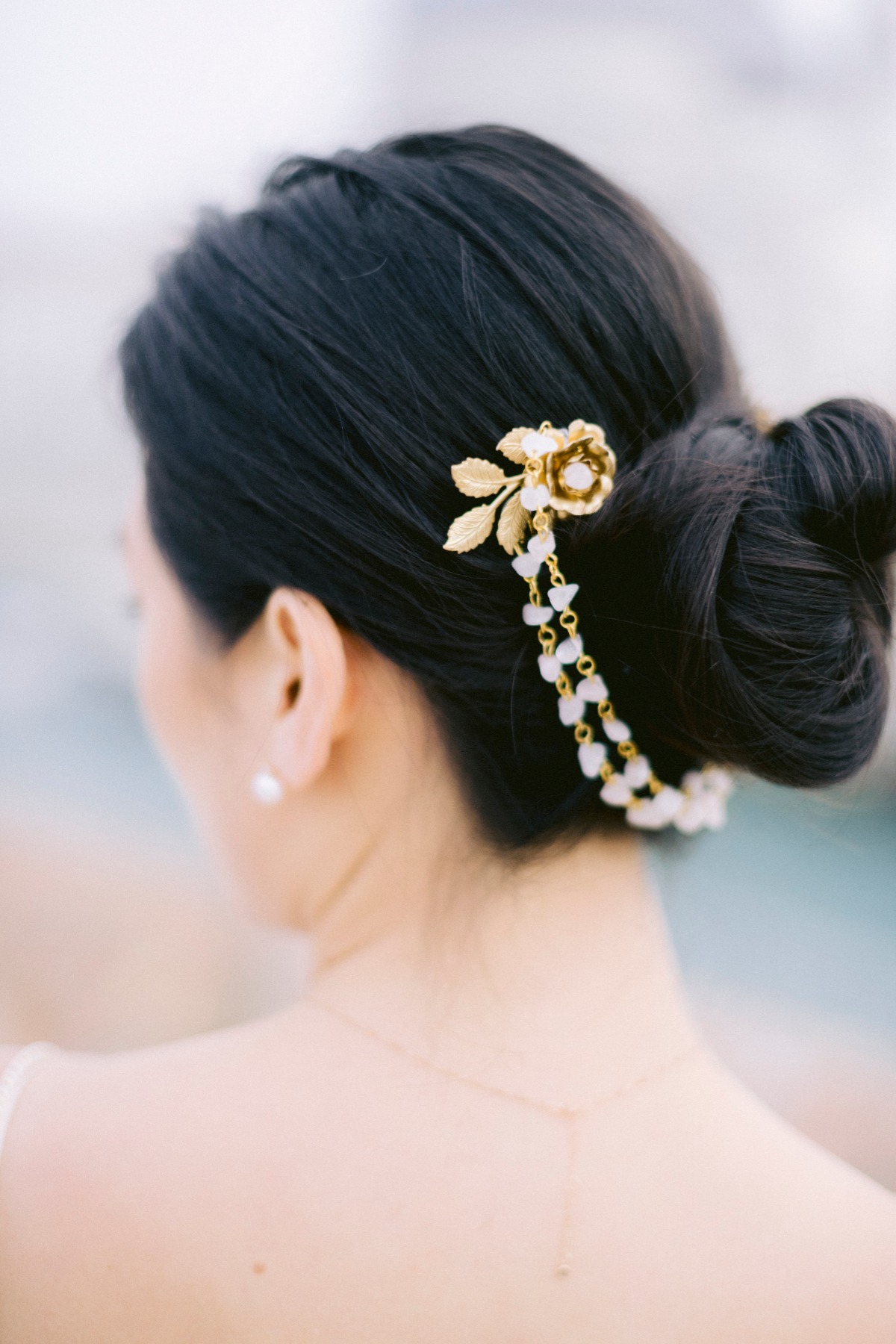 Elegant bride with updo and gold floral hair accessory