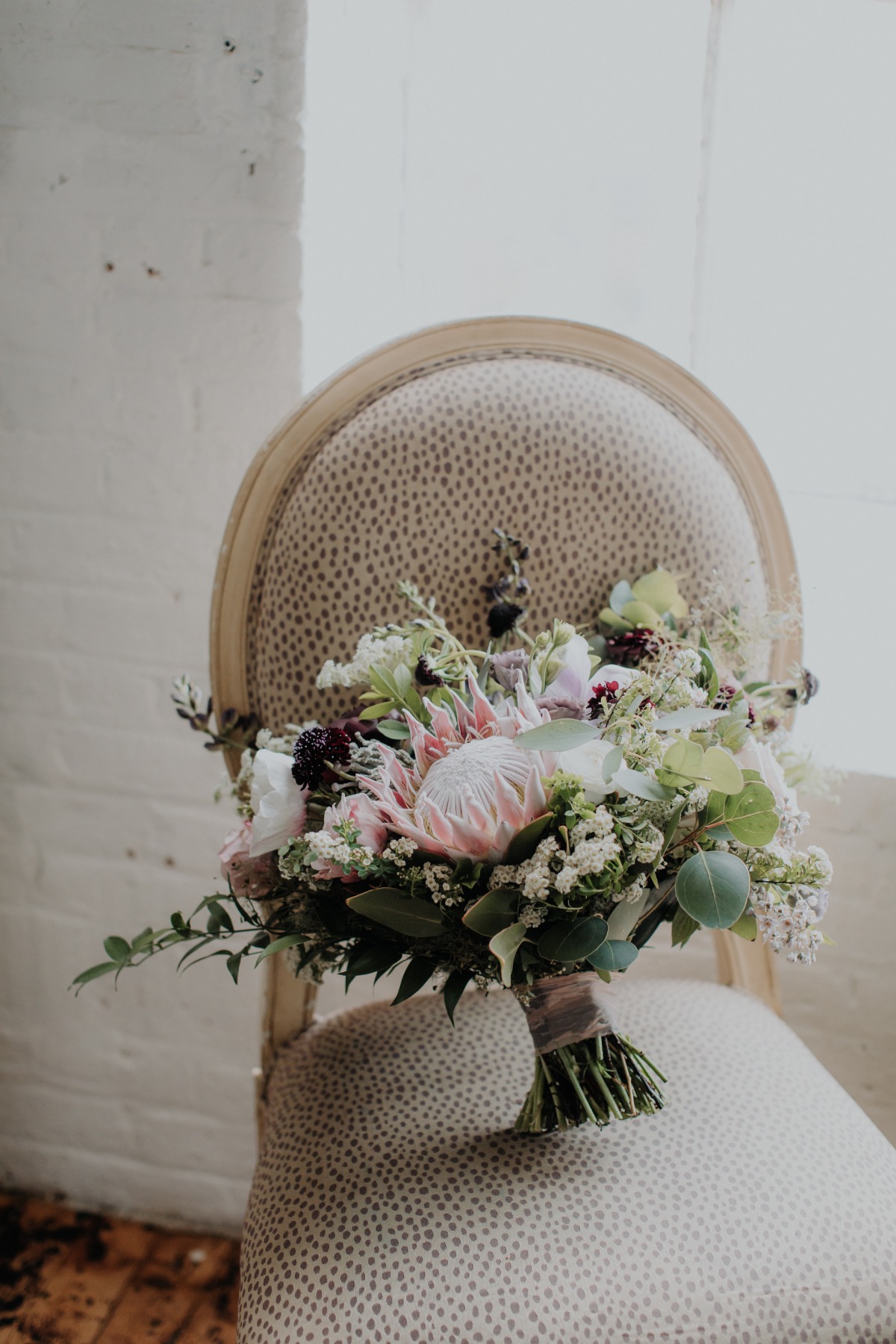 Protea and rose wedding bouquet designed by New Hampshire wedding florist, Apotheca Flowers.