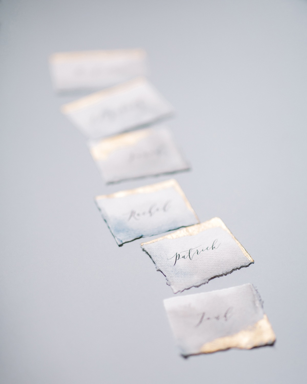 escort cards on handmade paper with gold edges designed by A Pajarita