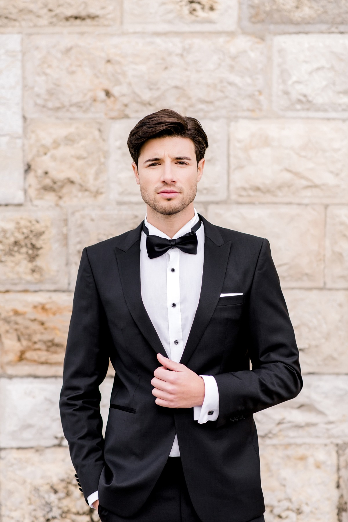 groom in black tie tuxedo