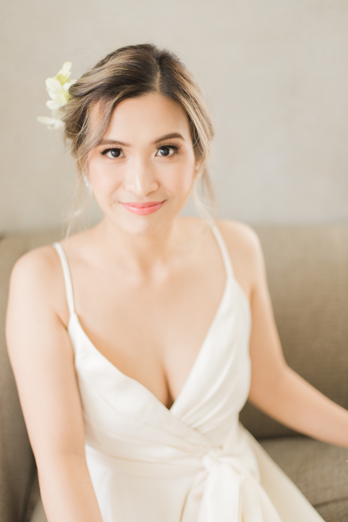 bride has an updo with orchids in her hair