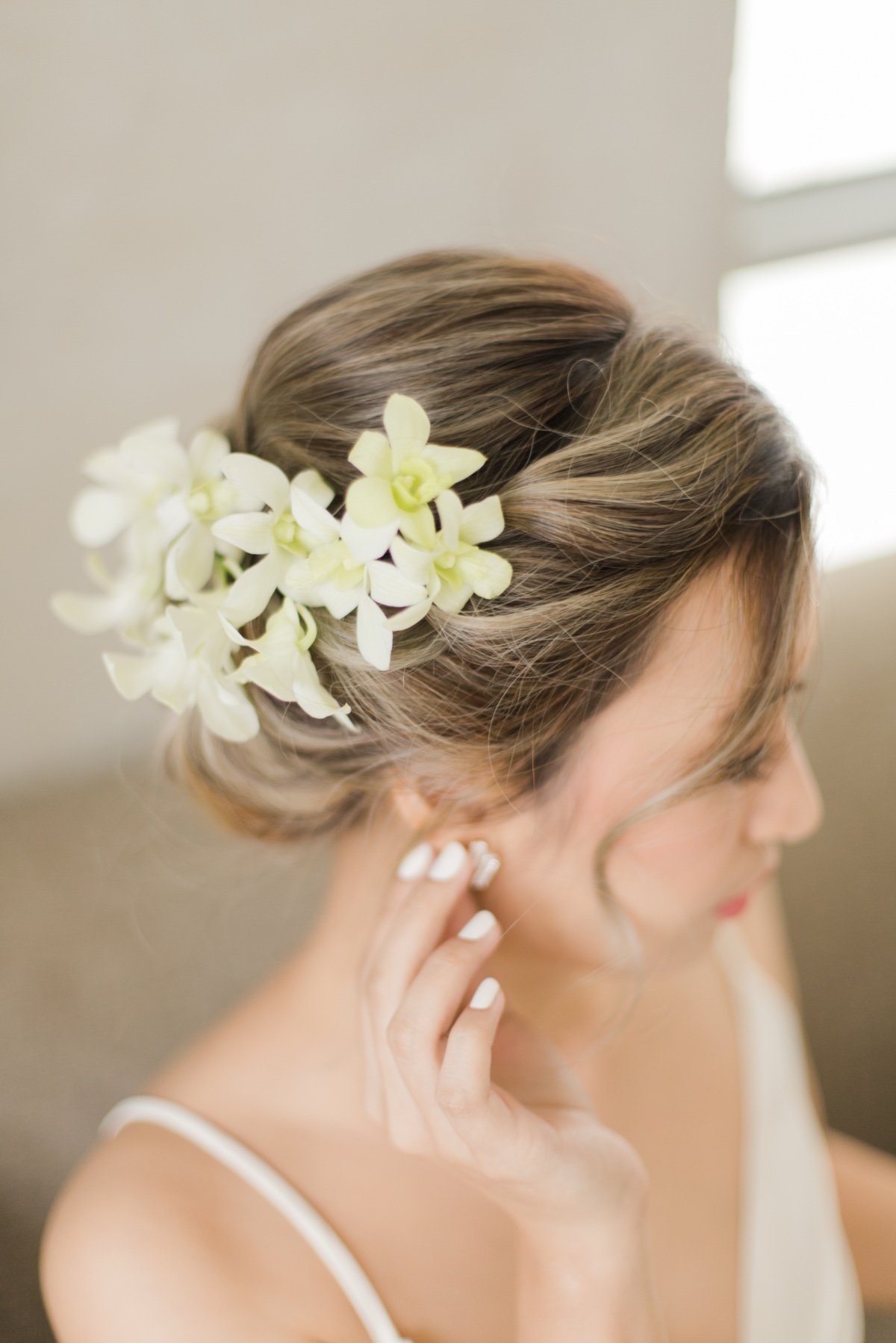 bride has an updo with orchids in her hair