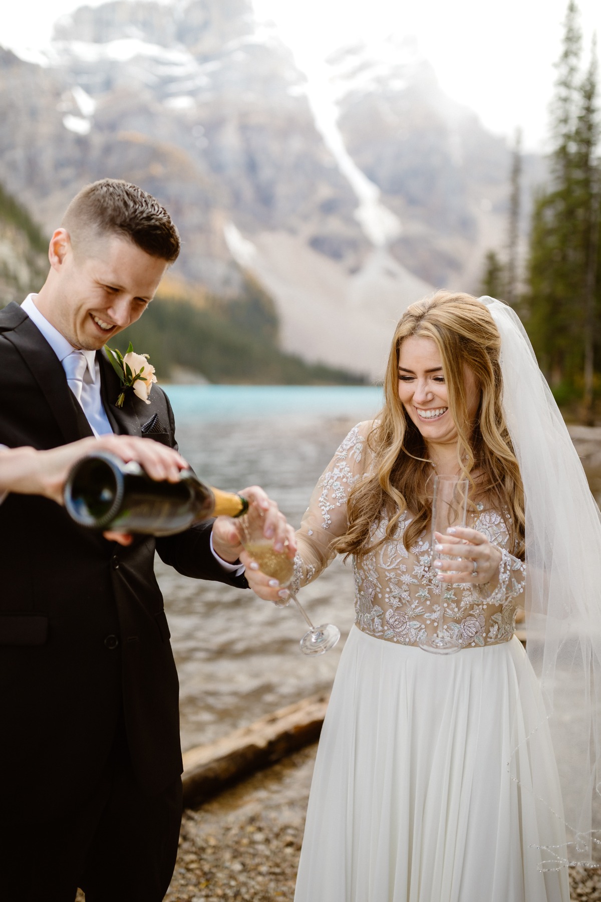 Champagne toast on shore of  Moraine Lake