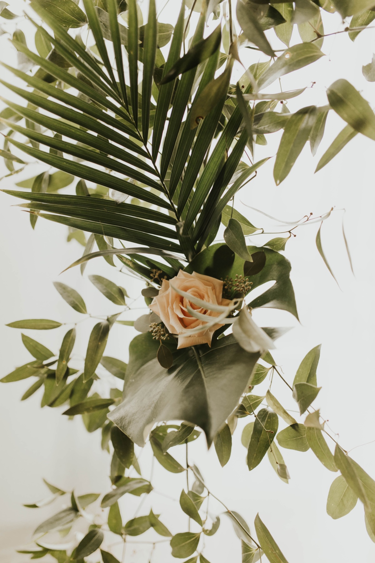 greenery mixed with palm leaves for wedding backdrop